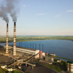 Aerial view of coal power plant high pipes with black smoke