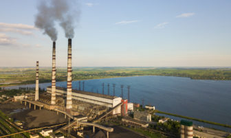 Aerial view of coal power plant high pipes with black smoke